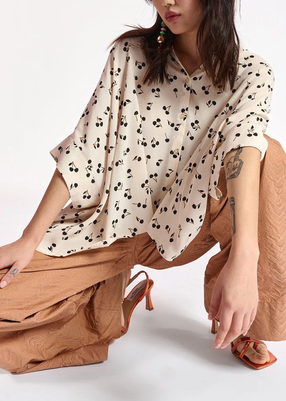 Off-white oversized top with black cherries motif