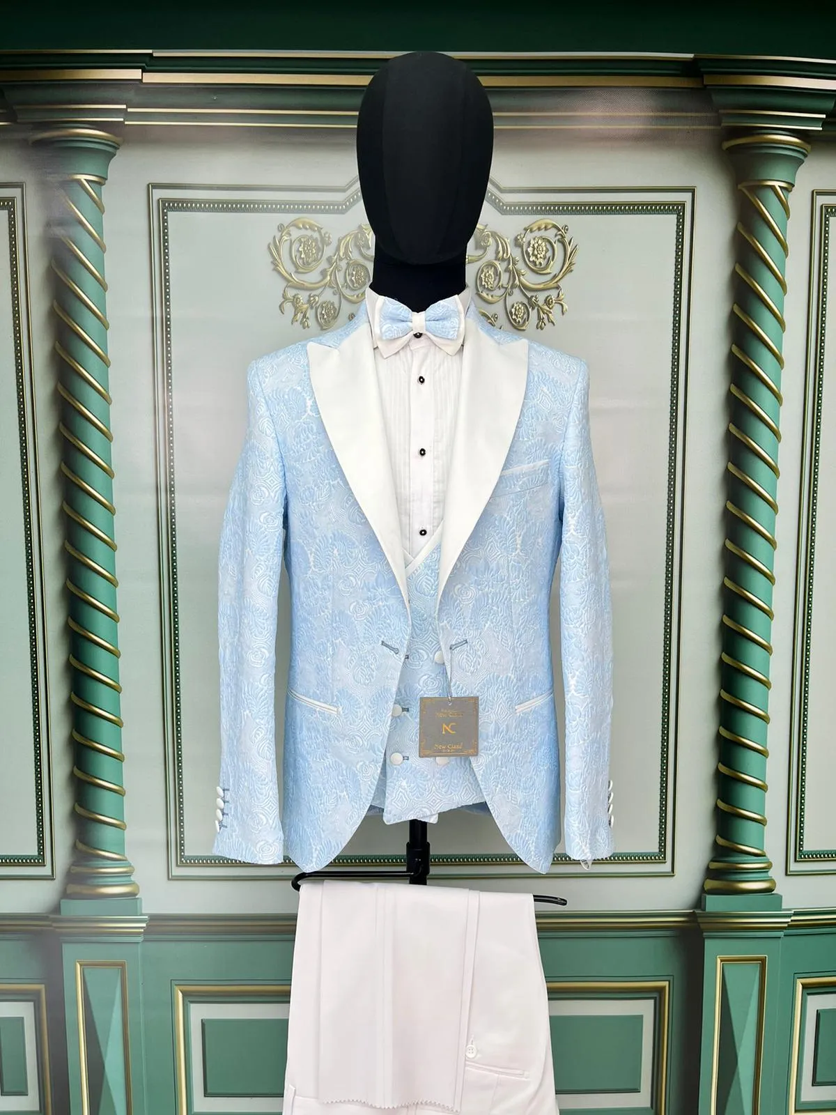 Single Button Three Pieces Tuxedo Suit with contrasting green velvet Lapel, matching bow tie and Black Pants.