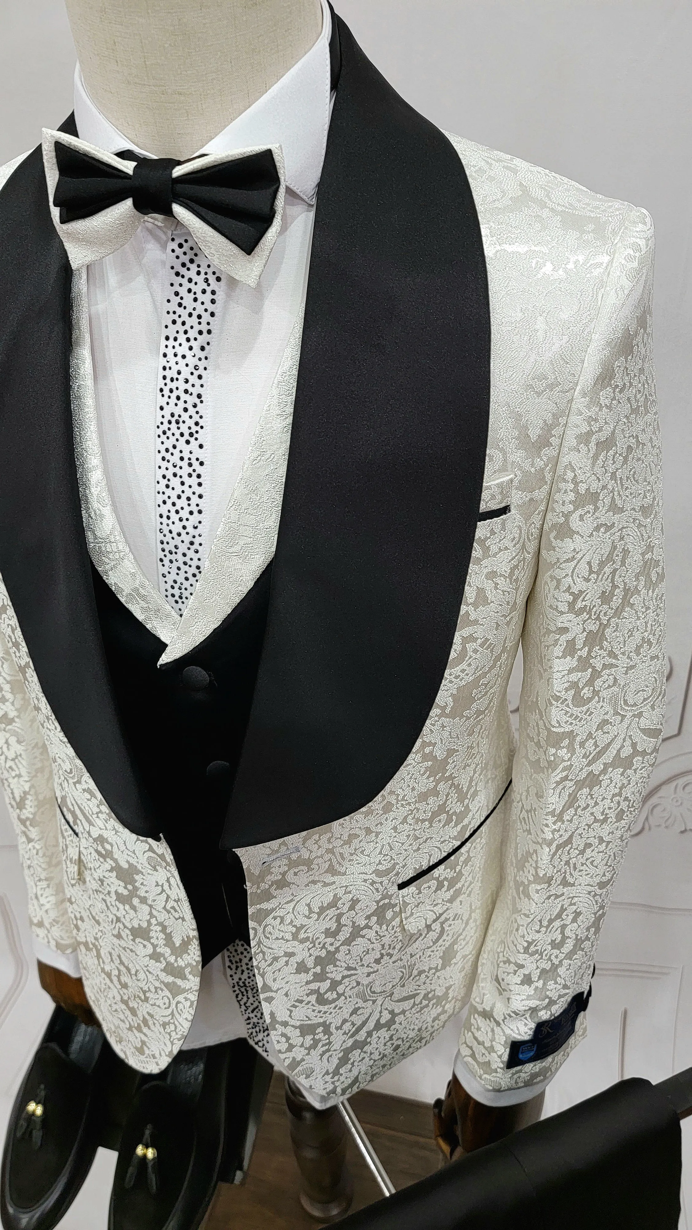 Three Pieces Tuxedo Suit with Contrasting Black Satin Lapel, matching bow tie and Black Pants.