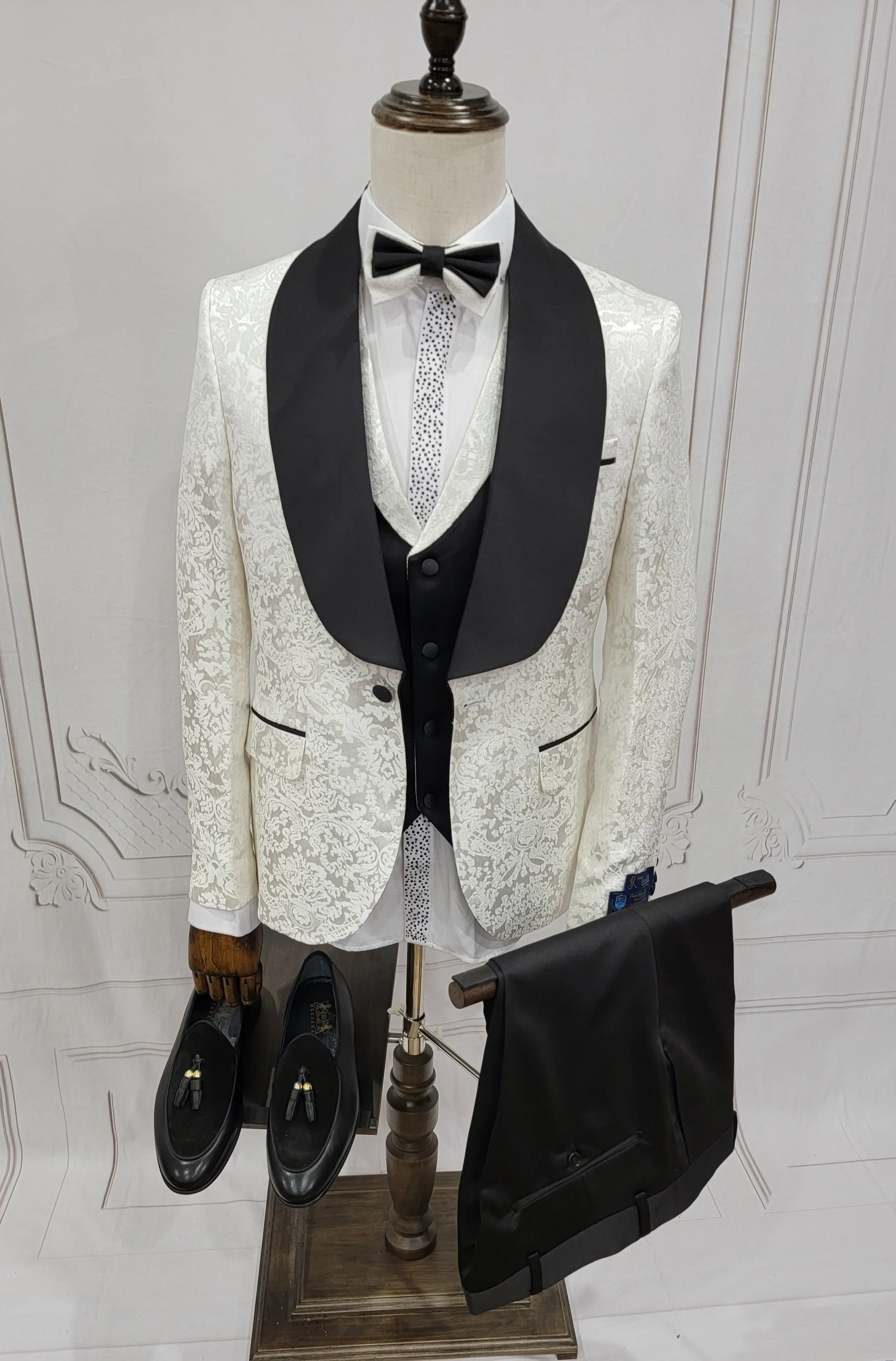 Three Pieces Tuxedo Suit with Contrasting Black Satin Lapel, matching bow tie and Black Pants.