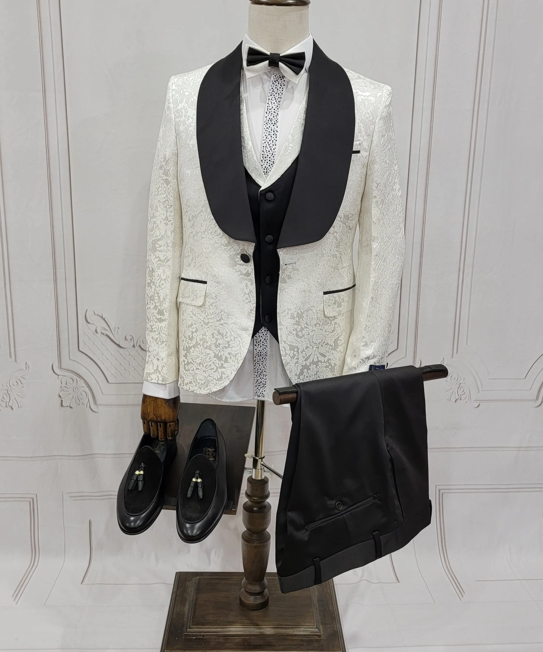 Three Pieces Tuxedo Suit with Contrasting Black Satin Lapel, matching bow tie and Black Pants.